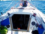 In the cockpit looking forward onto deck and the companion way that leads down into the bowels of our stallion-pony hybrid. The orange thing in front of the mast is the inflatable kayak.