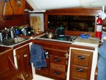 Our two-burner wonder of a galley fueled by a 20-lb. canister of propane that we keep in the cockpit. Sink has a foot pump attached to our water tank, only 26 gallons.  We will carry another 50 in jerry cans and bottles for the crossing.  