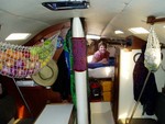 Behind the mast is the head, another wall, and then the v-berth; closet off to the right. The black thing on ceiling is a newly installed hatch-big difference. Poorly ventilated, but it was made to be water-tight, empty and fast, not the winnabago that we�ve turned it into. The thing on the mast is a mola, hand-made by the Kuna indians in Panama.
