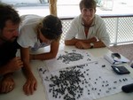 Looking at pearls. We should have bought more! At one point, there were 50-some farms in the lagoon. Now there are only 3. We found a lot of trash left over from these operations.
