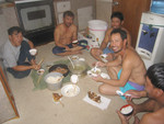The family sit down. John's dinner is the tiny bowl of rice and the fried fishhead, bottom center. The cockroaches were so numerous you only knock them off yourself when they got near your face. Crews consisted of a captain and 4 deckhands who were typically from Philipines, Vietman, Korea, and Micronesia.